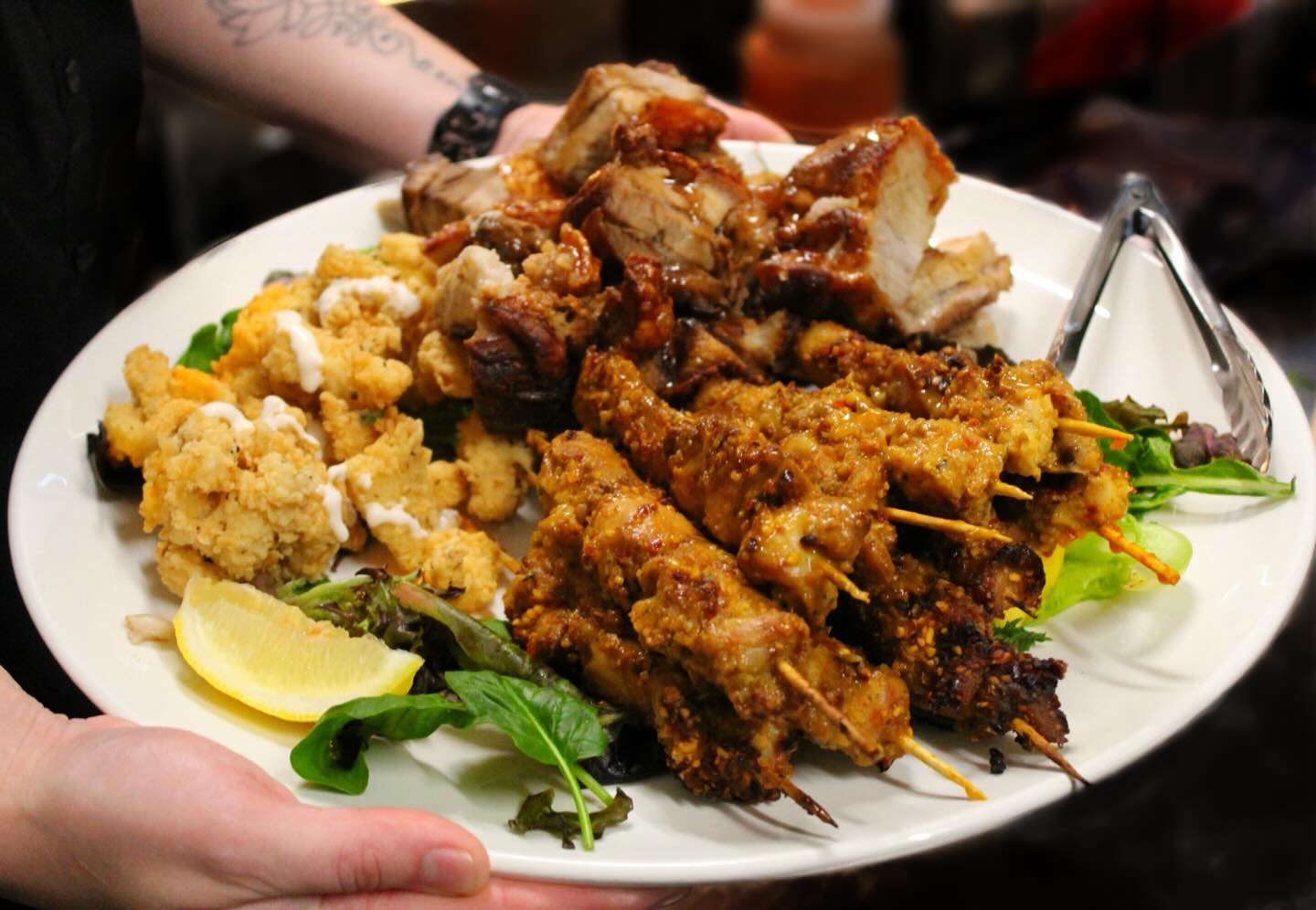 Canapé platter with satay skewers and fried bites prepared by Club Da Vinci
